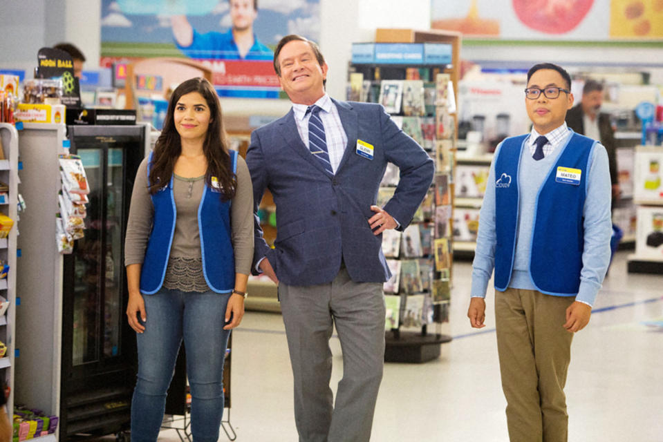 America Ferrera, Mark McKinney, and Nico Santos stand together in the aisle of their store