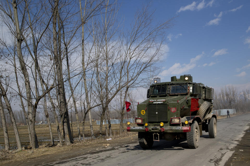 An Indian army armored vehicle rushes towards the site of a gun battle in Pulwama, south of Srinagar, Indian controlled Kashmir, Monday, Feb. 18, 2019. Tensions continued to rise in the aftermath of a suicide attack in disputed Kashmir, with seven people killed Monday in a gunbattle that broke out as Indian soldiers scoured the area for militants. (AP Photo/ Dar Yasin)