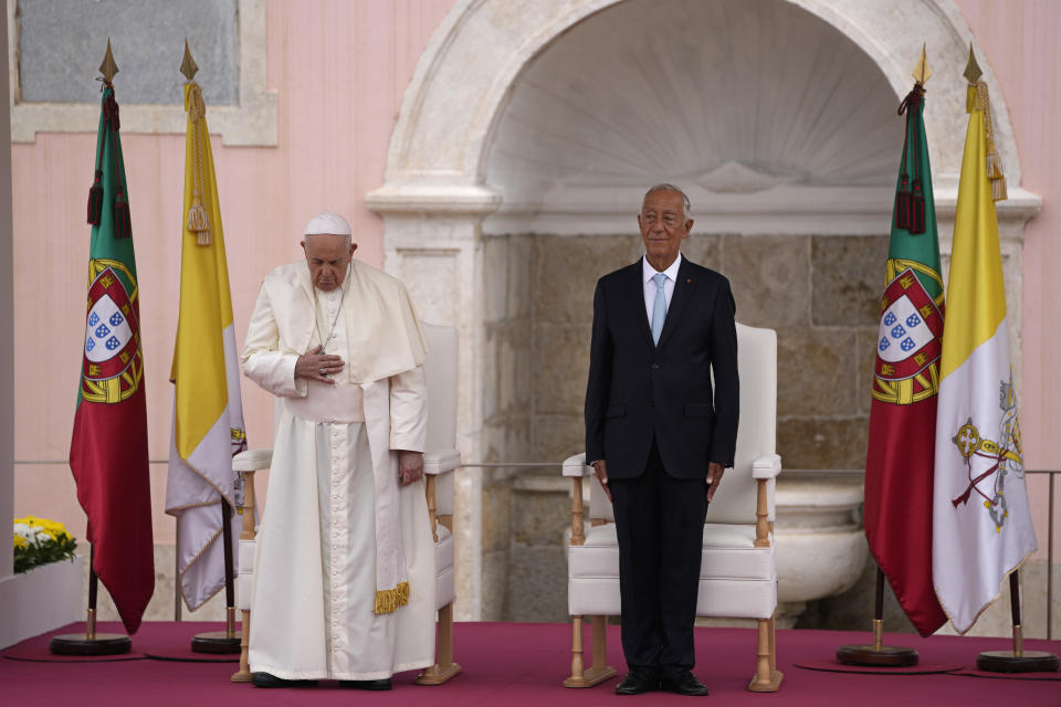 Pope Francis and Portugal's President Marcelo Rebelo de Sousa, right, listen to the Portuguese national anthem at the Welcome Ceremony at the Belem presidential palace in Lisbon, Wednesday, Aug. 2, 2023. Pope Francis starts his five-day pastoral visit to Portugal Wednesday that includes his participation at the 37th World Youth Day, and a pilgrimage to the holy shrine of Fatima. (AP Photo/Armando Franca)