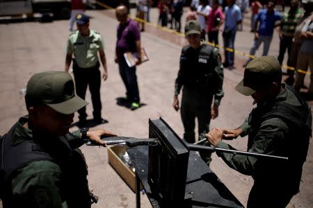 Venezuelan National Guard destroy a weapon during an exercise to disable seized weapons in Caracas, Venezuela, August 17, 2016. REUTERS/Marco Bello