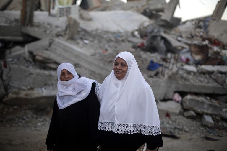 Palestinian women walk past the rubble of buildings that were destroyed during the 50-day war between Israel and Hamas militants in the summer of 2014, in Gaza City's al-Shejaiya neighbourhood, on March 31, 2015