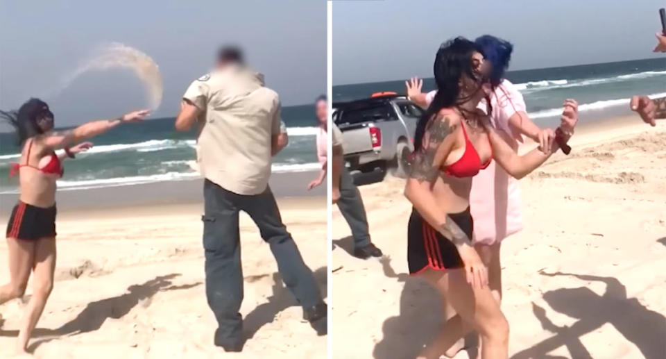 The woman in a red bikini can be seen throwing sand at one of the rangers (left) before shouting at bystanders (right) on the beach on Bribie Island. 