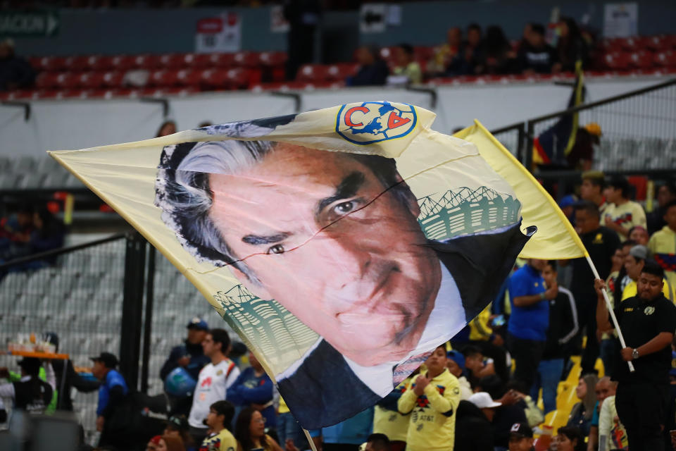 MEXICO CITY, MEXICO - JANUARY 18: A fan of America waves a flag with a picture of the former owner of Club America Emilio Azcarraga 'El Tigre' before the 2nd round match between America and Tigres UANL as part of the Torneo Clausura 2020 Liga MX at Azteca Stadium on January 18, 2020 in Mexico City, Mexico. (Photo by Hector Vivas/Getty Images)