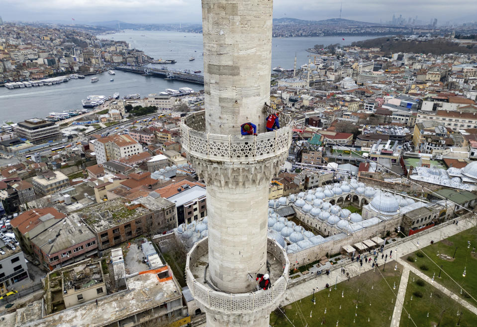 Mahya masters work in the installation of a lights message at the top of one of the minarets of the Suleymaniye mosque ahead of the Muslim holy month of Ramadan, in Istanbul, Turkey, Wednesday, March 6, 2024. Mahya is the unique Turkish tradition of stringing religious messages and designs between minarets. (AP Photo/Emrah Gurel)