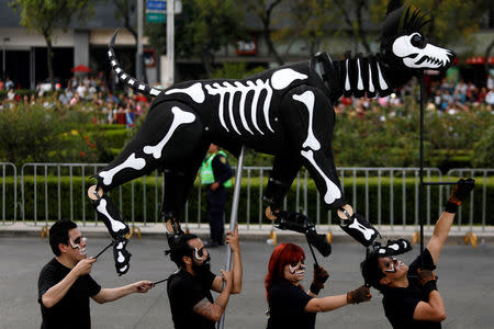 A puppet depicting the skeleton of a dog participates in a procession to commemorate Day of the Dead in Mexico City, Mexico, October 28, 2017. REUTERS/Edgard Garrido