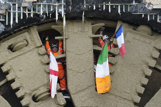 HS2 workers wave flags after boring machine Cecelia completing its 10-mile journey under the Chiltern Hills