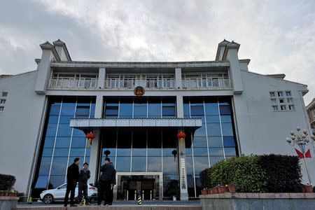 Men gather outside a building of the county government in Rucheng county, Hunan province, China December 3, 2018. Picture taken December 3, 2018. To match Insight CHINA-ECONOMY/DEBT-RUCHENG. REUTERS/Shu Zhang