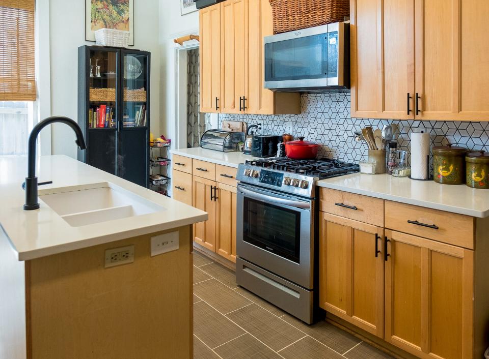 A spacious kitchen island provides additional room for the kitchen sink and dishwasher, plus extra work space on the counter.