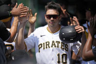 Pittsburgh Pirates' Bryan Reynolds (10) celebrates in the dugout after scoring one of two runs on a single by Ji Hwan Bae off St. Louis Cardinals starting pitcher Miles Mikolas, during the first inning of a baseball game in Pittsburgh, Sunday, June 4, 2023. (AP Photo/Gene J. Puskar)