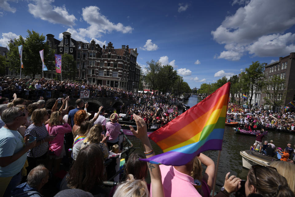 Hundreds of thousands of people lined canals in the Dutch capital to watch the colorful spectacle of the Pride Canal Parade return for the 25th edition after the last two events were canceled due to the COVID-19 pandemic, in Amsterdam, Netherlands, Saturday, Aug. 6, 2022. (AP Photo/Peter Dejong)