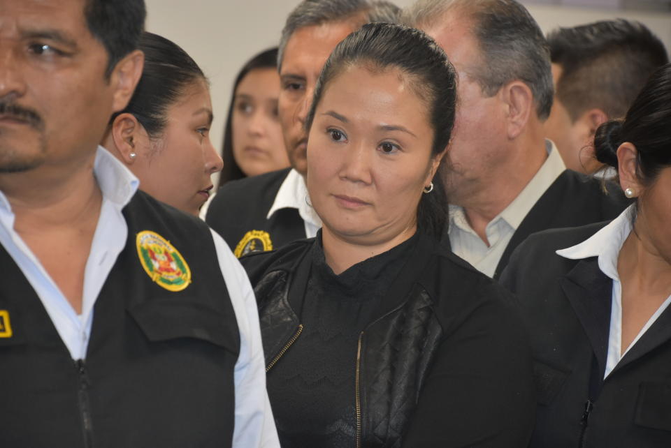 In this photo provided by Peru's Supreme Court communications office, former Peruvian first daughter Keiko Fujimori stands in court where Judge Richard Concepcion ruled that she should be detained as a preventative measure while prosecutors investigate allegations she led a criminal network within her party that received about $1 million in payments from Brazilian construction giant Odebrecht, in Lima, Peru, Wednesday, Oct. 31, 2018. Keiko Fujimori denies she accepted money from Odebrecht during her 2011 presidential run and has called the investigation a political witch hunt. (Peru's Supreme Court communication office via AP)