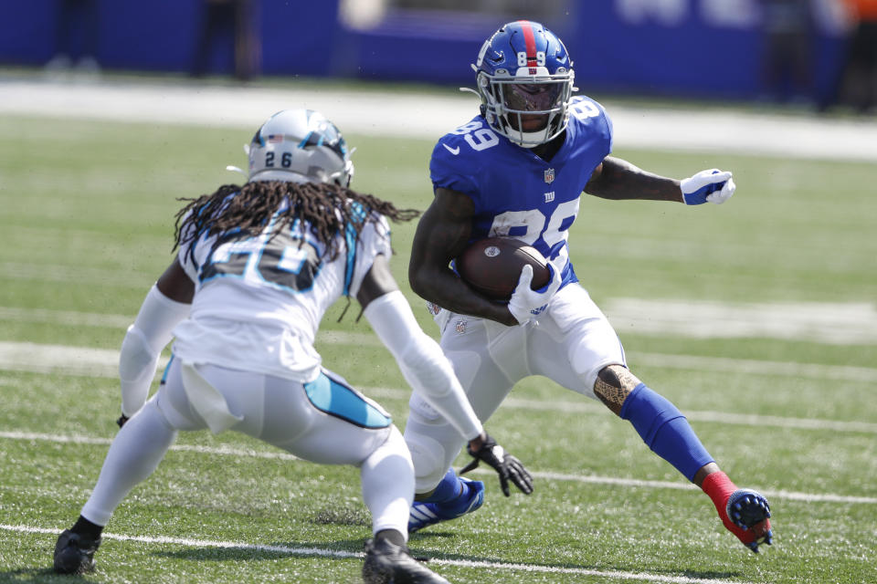 FILE - New York Giants' Kadarius Toney, right, runs with the ball during the first half an NFL football game against the Carolina Panthers, on Sept. 18, 2022, in East Rutherford, N.J. The Kansas City Chiefs acquired Giants wide receiver Kadarius Toney on Thursday, Oct. 27, 2022, for a pair of picks in next year's draft, a person familiar with the terms of the trade told The Associated Press. (AP Photo/Noah K. Murray, File)