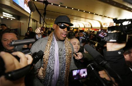 Former NBA basketball player Dennis Rodman speaks to the media after returning from his trip to North Korea at Beijing airport, December 23, 2013. REUTERS/Jason Lee