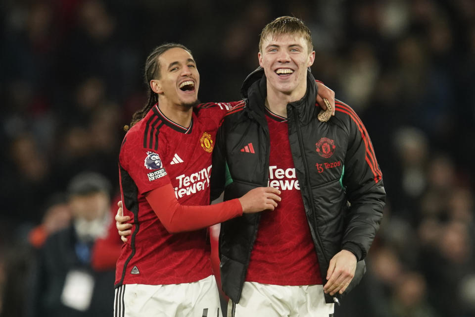 Manchester United's Alejandro Garnacho, right, celebrates with Manchester United's Hannibal Mejbri on the full time during the English Premier League soccer match between Manchester United and Aston Villa at the Old Trafford stadium in Manchester, England, Tuesday, Dec. 26, 2023. Manchester United won 3-2. (AP Photo/Dave Thompson)