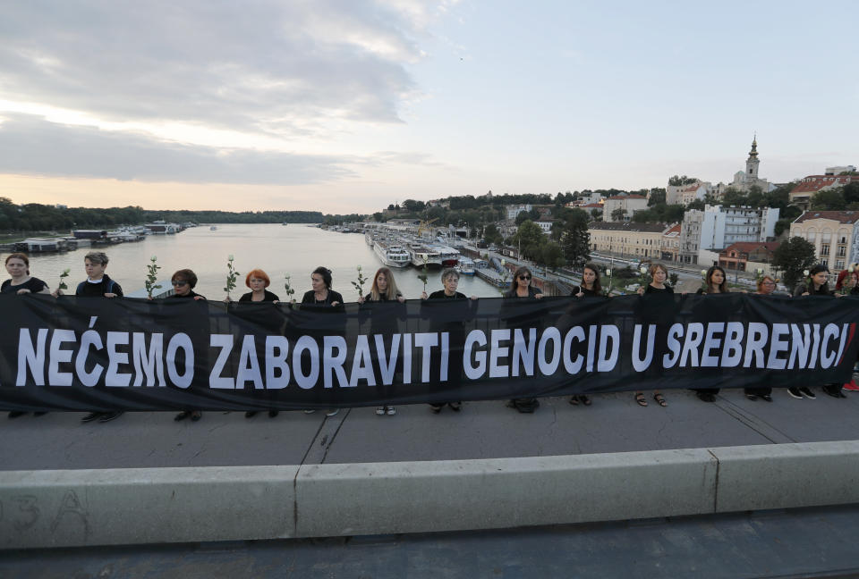 Members of anti-war organization "Women in Black", hold a banner that reads: "We will not forget the genocide in Srebrenica!'' as part of a meeting to mark the 24th anniversary of the Srebrenica tragedy, in Belgrade, Serbia, Wednesday, July 10, 2019. (AP Photo/Darko Vojinovic)