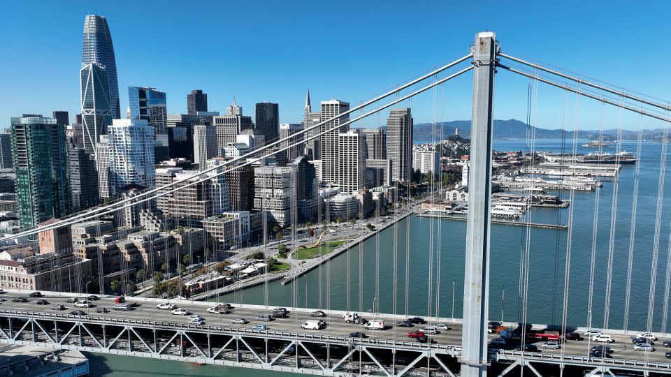 In an aerial view, cars drive by the San Francisco skyline as they cross the San Francisco-Oakland Bay Bridge on October 27, 2022 in San Francisco, California. According to a report by commercial real estate firm CBRE, the city of San Francisco has a record 27.1 million square feet of office space available as the city struggles to rebound from the Covid-19 pandemic.  - Justin Sullivan/Getty Images