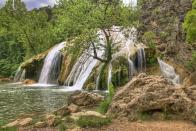 <p>There's a reason <a href="https://www.tripadvisor.com/Attraction_Review-g51303-d117492-Reviews-Turner_Falls_Park-Davis_Oklahoma.html" rel="nofollow noopener" target="_blank" data-ylk="slk:Turner Falls Park;elm:context_link;itc:0;sec:content-canvas" class="link ">Turner Falls Park</a> is a favorite swimming hole for locals: It's home to an impressive 77-foot tall waterfall that you can swim underneath. After taking a dip, explore the rock castle that was built into the hillside nearby.</p>