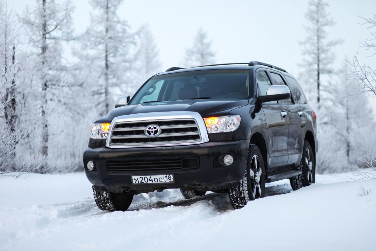 Novyy Urengoy, Russia - November 04, 2019: Black off-road vehicle Toyota Sequoia in the snow covered forest.