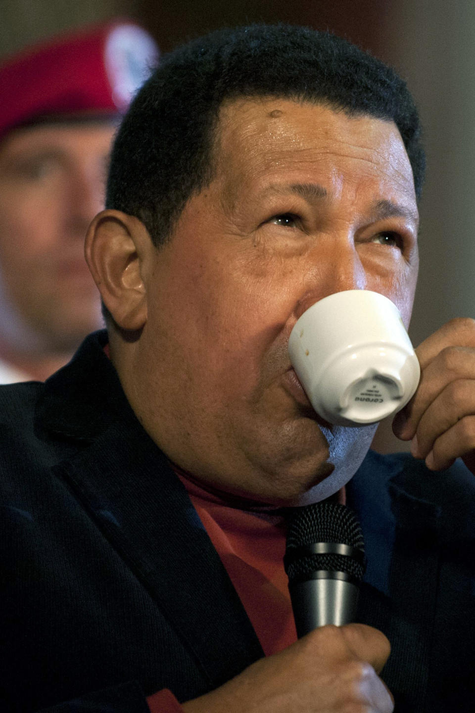Venezuelan President and presidential candidate Hugo Chavez drinks coffee during a press conference at Miraflores Palace in Caracas on October 6, 2012. Chavez, in power for almost 14 years, is vying for a fourth term in office that would extend his presidency by another six years, but opposition candidate Henrique Capriles hopes to pull a major upset in the presidential elections on October 7 elections. PHOTO/Eitan Abramovich        (Photo credit should read EITAN ABRAMOVICH/AFP/GettyImages)