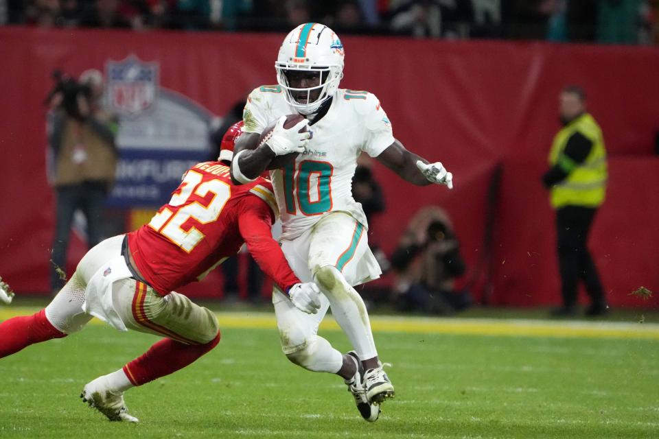 Nov 5, 2023; Frankfurt, Germany; Miami Dolphins wide receiver Tyreek Hill (10) carries the ball against Kansas City Chiefs linebacker Nick Bolton (32) in the second half during an NFL International Series game at Deutsche Bank Park. Mandatory Credit: Kirby Lee-USA TODAY Sports