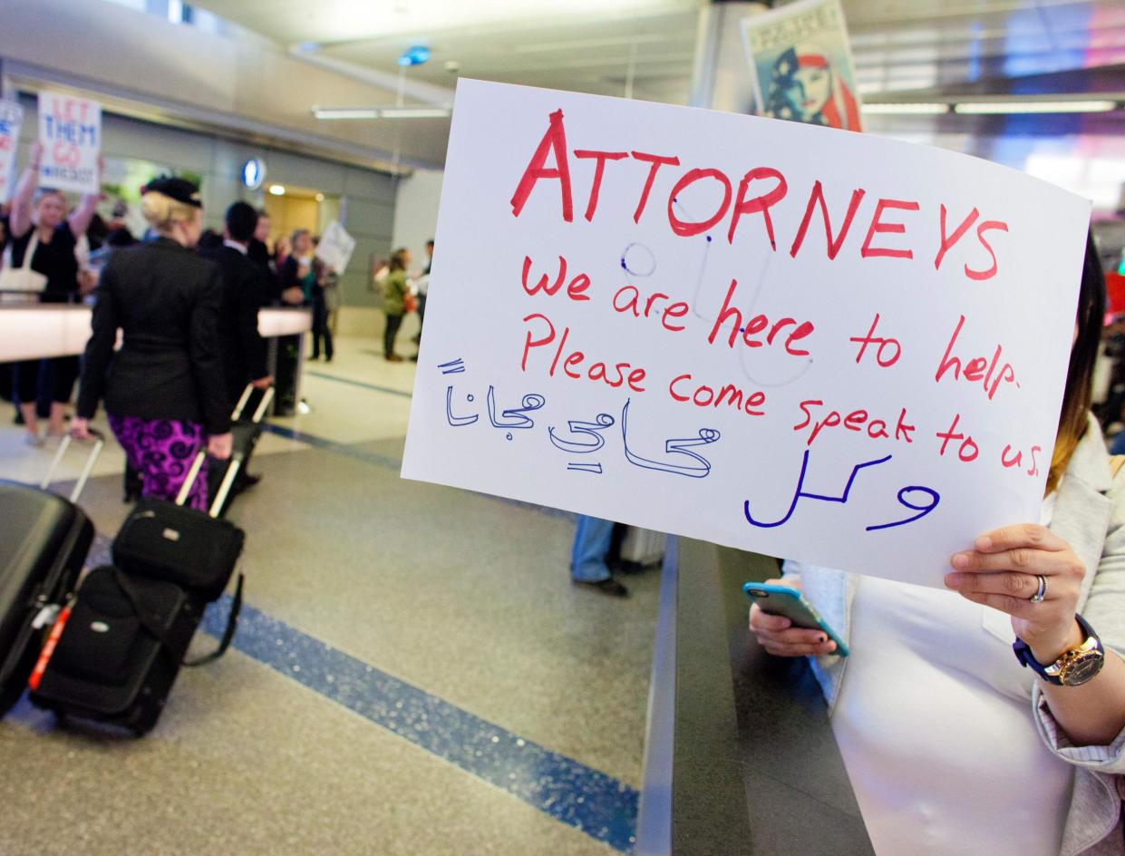 Volunteer lawyers join protesters at Los Angeles International airport, offering free legal assistance to stranded Muslims: AFP/Getty Images