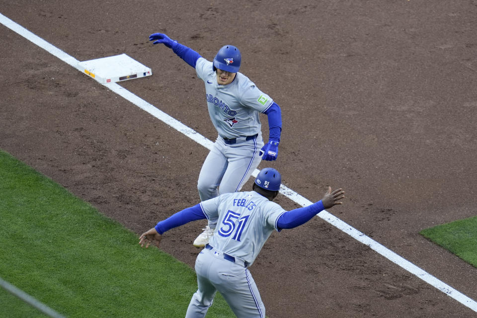 Toronto Blue Jays' Daulton Varsho, above, celebrates with third base coach Carlos Febles after hitting a three-run home run during the first inning of a baseball game against the San Diego Padres, Saturday, April 20, 2024, in San Diego. (AP Photo/Gregory Bull)