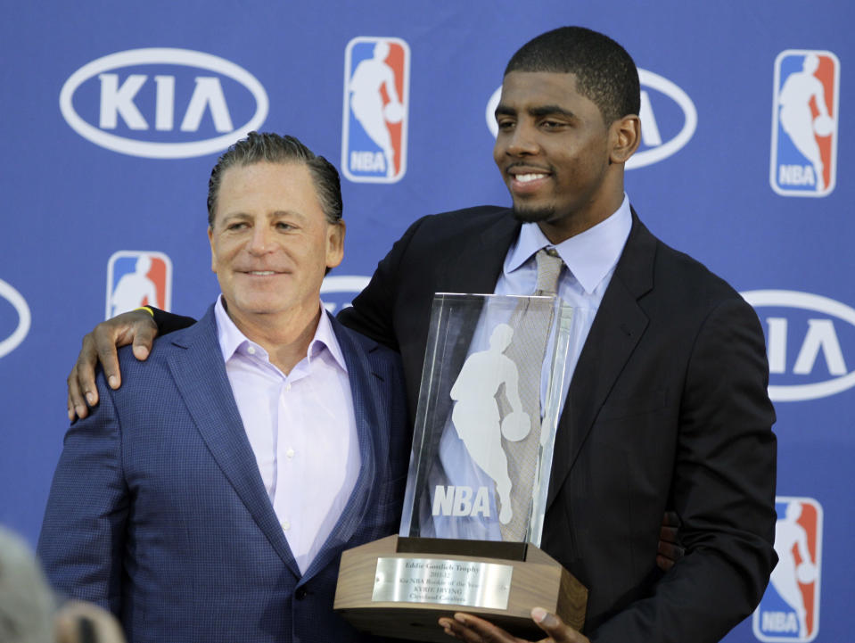 Cleveland Cavaliers' Kyrie Irving, right, poses with Cavaliers' owner Dan Gilbert after Irving was presented with the NBA Rookie of the Year award at the basketball team's headquarters in Independence, Ohio Tuesday, May 15, 2012. (AP Photo/Mark Duncan)