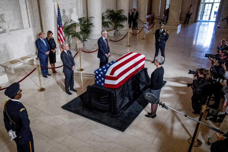 President Donald Trump and first lady Melania Trump pay their respects as the late Supreme Court Justice John Paul Stevens lies in repose in the Great Hall of the Supreme Court in Washington, Monday, July 22, 2019. (AP Photo/Andrew Harnik, pool)