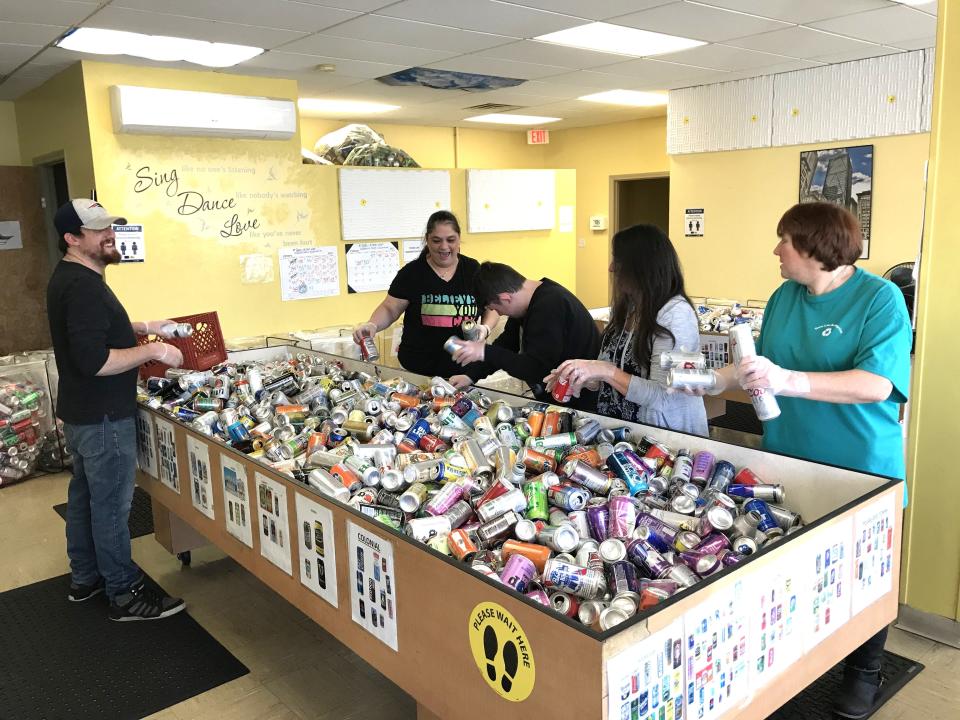 Townline Redemption Center employees  L-R Cody Shiverdecker, Michele Cabral, Zachary Taylor, assistant manager Jeannine Camara Jackson and Tricia Reed sort cans and bottles on Feb. 8 that will be shipped to beverage distributors that manufactured the contents.
