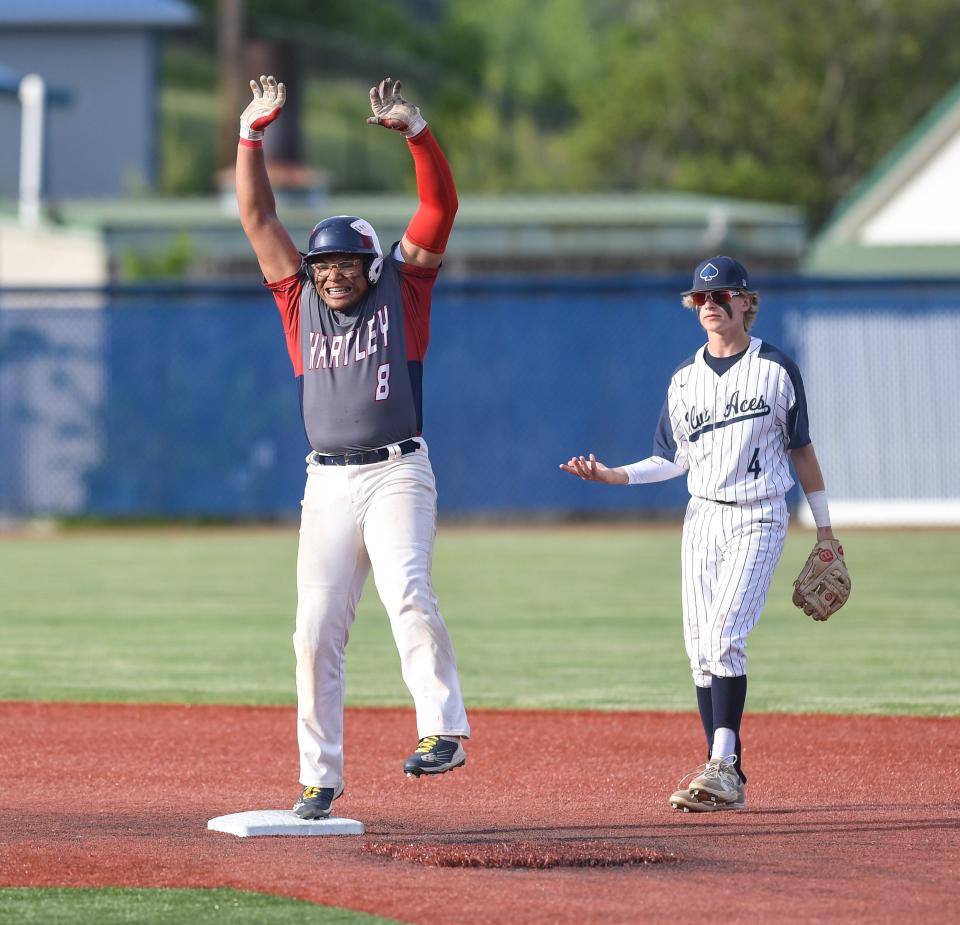 Hartley's DuShaun Tucker celebrates his double against Granville in a Division II district final May 25 at Beavers Field in Lancaster. The Hawks won 12-5.