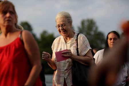 A woman smiles as she enters the Remote Area Medical Clinic in Wise, Virginia, U.S., July 21, 2017. .REUTERS/Joshua Roberts