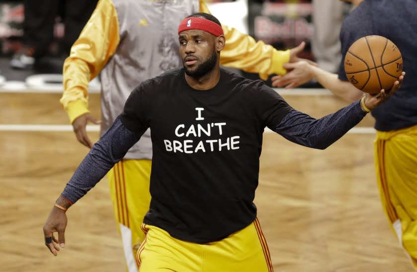 FILE - In this Dec. 8, 2014 file photo, Cleveland Cavaliers' LeBron James wears a T-shirt reading "I Can't Breathe," during warms up before an NBA basketball game against the Brooklyn Nets in New York. Celebrities have long played a significant role in social change, from Harry Belafonte marching for civil rights to Muhammad Aliâ€™s anti-war activism. James and other basketball stars made news in 2014 when they wore T-shirts to protest the death of Eric Garner. (AP Photo/Frank Franklin II, File)
