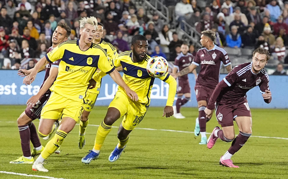 From front left to right, Nashville SC defenders Lukas MacNaughton, Nashville's Shaq Moore and Colorado Rapids midfielder Sidnei Tavares pursue the ball during the first half of an MLS soccer match Saturday, March 2, 2024, in Commerce City, Colo. (AP Photo/David Zalubowski)