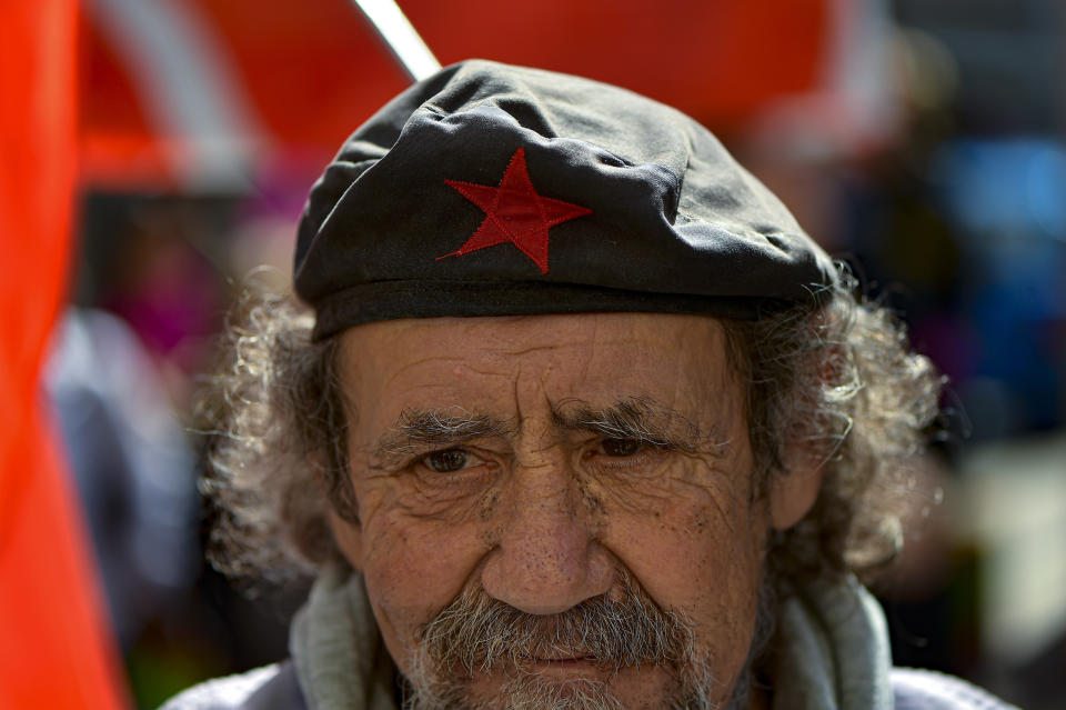 A man wearing a beret decorated with a traditional communist red star takes part in a May Day rally, in Pamplona, northern Spain, Monday, May 1, 2023. (AP Photo/Alvaro Barrientos)