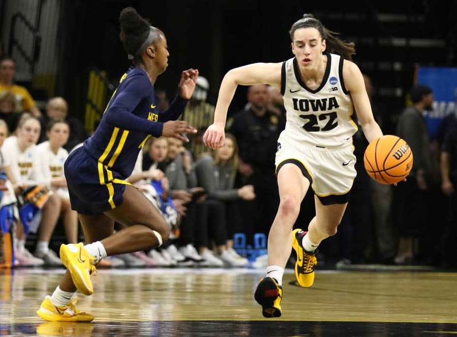 IOWA CITY, IOWA- MARCH 25: Guard Caitlin Clark #22 of the Iowa Hawkeyes goes to the basket during the first half against guard Jordan Harrison #10 of the West Virginia Mountaineers during their second round match-up in the 2024 NCAA Division 1 Women’s Basketball Championship at Carver-Hawkeye Arena on March 25, 2024 in Iowa City, Iowa. (Photo by Matthew Holst/Getty Images)