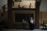 In this April 14, 2019 photo, Yusra Dhanoun's grandchildren play in her house in Mosul, Iraq. Her three sons were killed by Islamic State militants in an attack in January. (AP Photo/Felipe Dana)