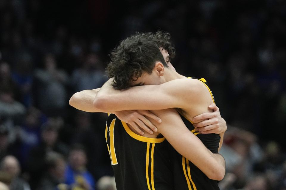 Pittsburgh's Jorge Diaz Graham, left, and Guillermo Diaz Graham hug after Pittsburgh defeated Mississippi State in a First Four game in the NCAA men's college basketball tournament Tuesday, March 14, 2023, in Dayton, Ohio. (AP Photo/Darron Cummings)