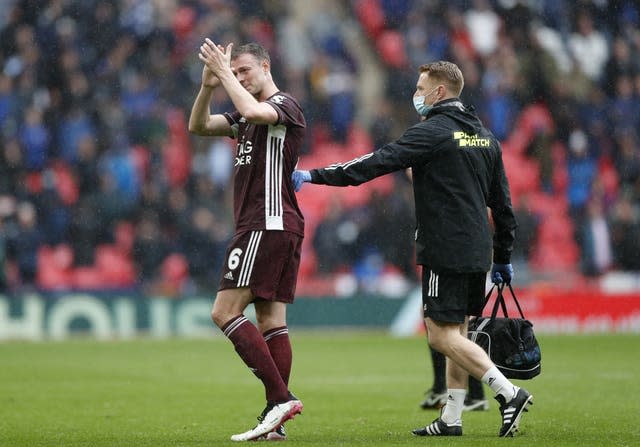 Jonny Evans applauds the fans as he leaves the pitch through injury 