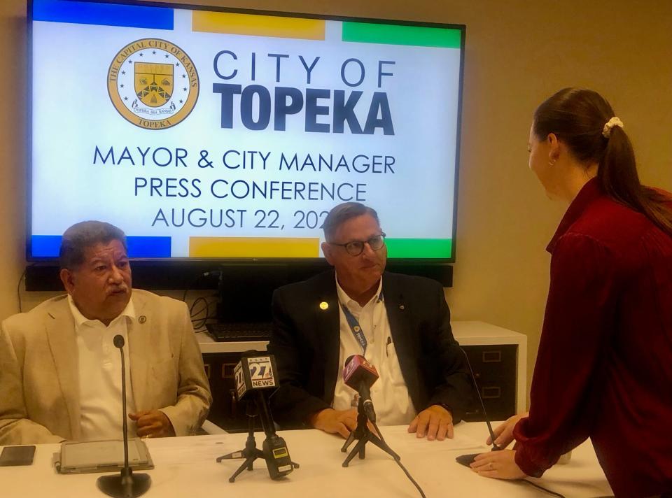 Topeka mayor Mike Padilla, left, and interim city manager Richard Nienstedt, middle, talk with communications director Gretchen Spiker during Tuesday's news conference.