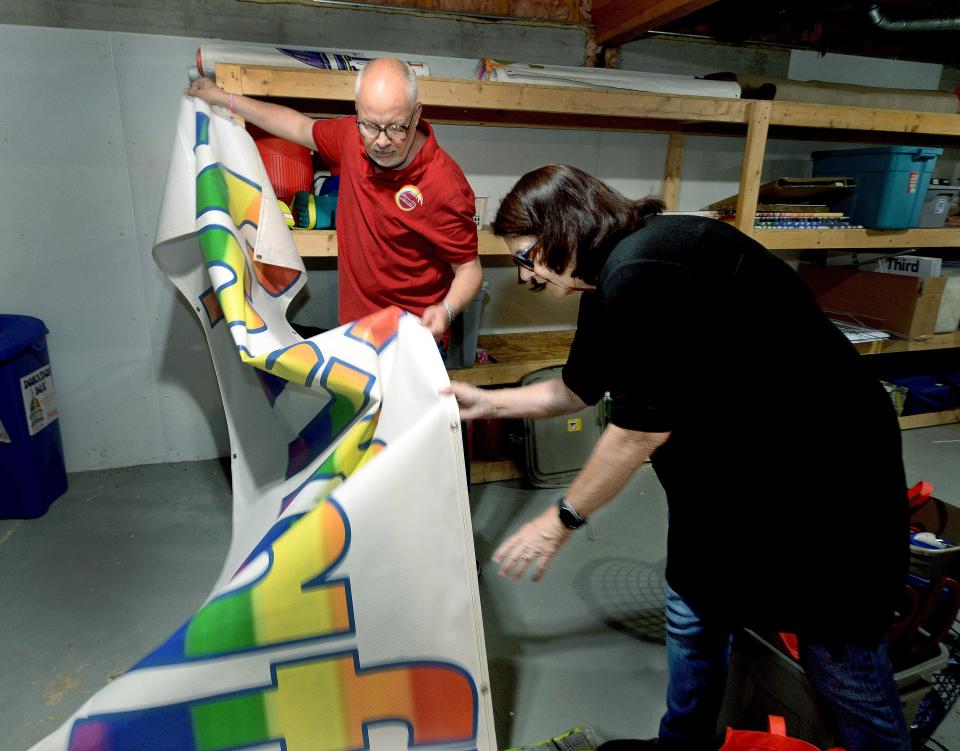 Director of Operations for the Phoenix Center Duane Williams, left, and Executive Director for the Phoenix Center Jonna Cooley, look over a Springfield Pride banner on Wednesday, May 15, 2024, as they get things ready for Saturday's PrideFest.