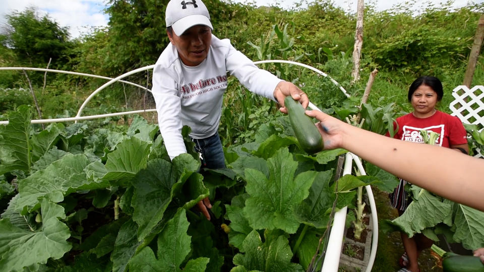 Community members bond while growing their own food in the garden.  (Hannah Letinich)