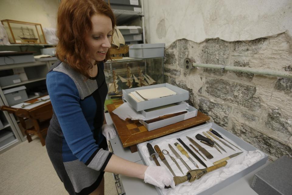 In this Tuesday, March 12, 2013 photo, Erica Harman, during an interview with the Associated Press, shows examples of shanks made by inmates at the Eastern State Penitentiary in Philadelphia. The defunct and decayed prison that serves as one of Philadelphia's quirkiest tourist attractions, plans to displaying dozens of never-before-seen artifacts for 10 days only in a "pop-up museum." (AP Photo/Matt Rourke)