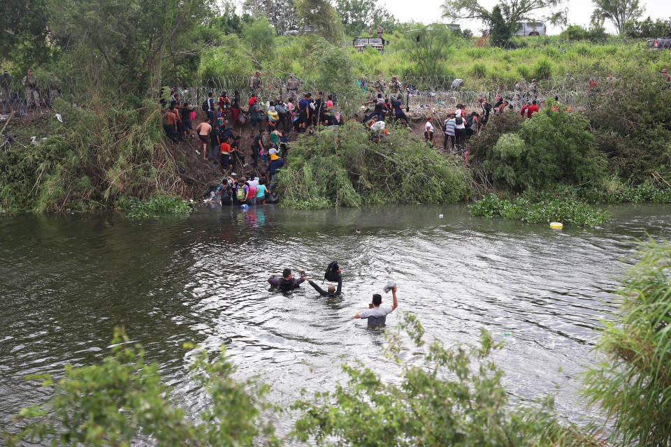 Migrants cross the Rio Grande in Matamoros, Mexico while traveling to the United States border, (Joe Raedle / Getty Images)