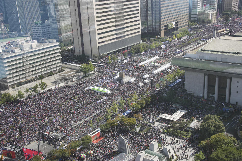 Thousands of demonstrators gather during a rally in Seoul, South Korea, Wednesday, Oct. 9, 2019. Thousands of protesters rallied Wednesday in South Korea's capital for the second consecutive week to call for the ouster of President Moon Jae-in's hand-picked justice minister, whose family is at the center of an investigation into allegations of financial crimes and academic favors. (Kim Seung-doo/Yonhap via AP)