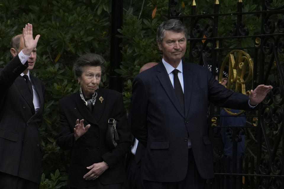 Princess Anne, centre, waves to the public after viewing the floral tributes to her mother Queen Elizabeth II, outside the gates of Balmoral Castle in Aberdeenshire, Scotland Saturday, Sept. 10, 2022. Queen Elizabeth II, Britain's longest-reigning monarch and a rock of stability across much of a turbulent century, died Thursday after 70 years on the throne. She was 96. (AP Photo/Alastair Grant)