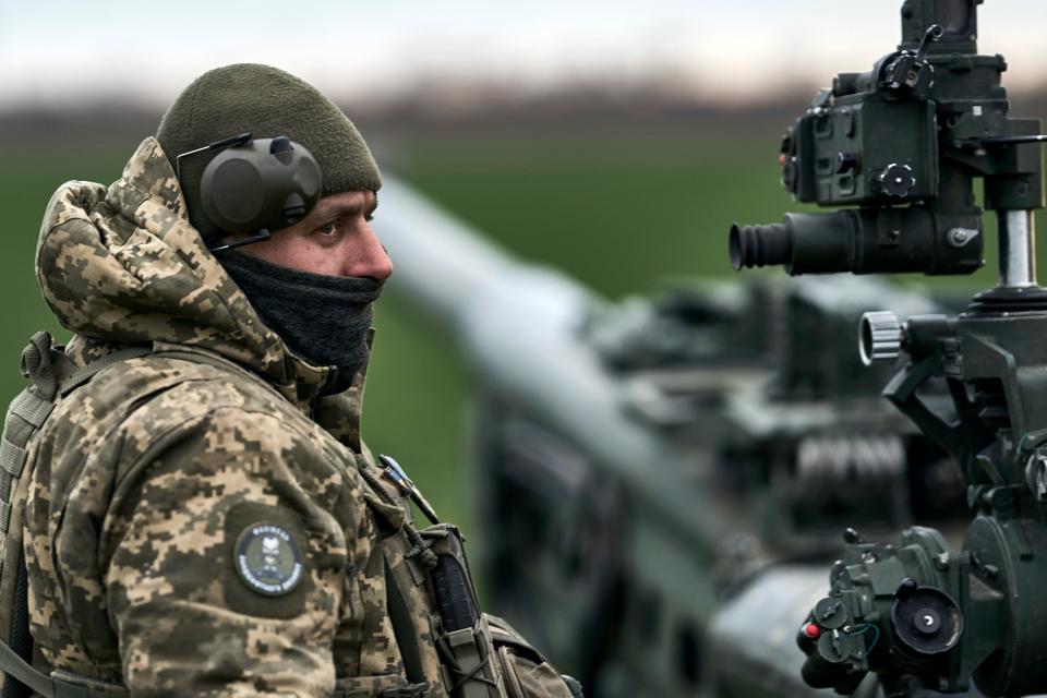 A Ukrainian soldier prepares a U.S.-supplied M777 howitzer to fire at Russian positions in the Kherson region, Ukraine, Jan. 9, 2023.
