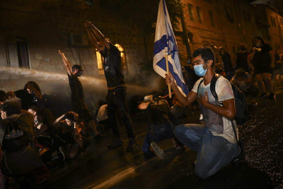 Israeli police uses water canon to disperse people during a protest against Israeli Prime Minister Benjamin Netanyahu In Jerusalem Saturday, July 18, 2020. Protesters demanded that the embattled Israeli leader to resign as he faces a trial on corruption charges and grapples with a deepening coronavirus crisis.(AP Photo/Oded Balilty)