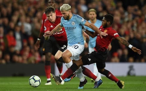 Sergio Aguero, Victor Lindelof and Fred battle for the ball - Credit: afp