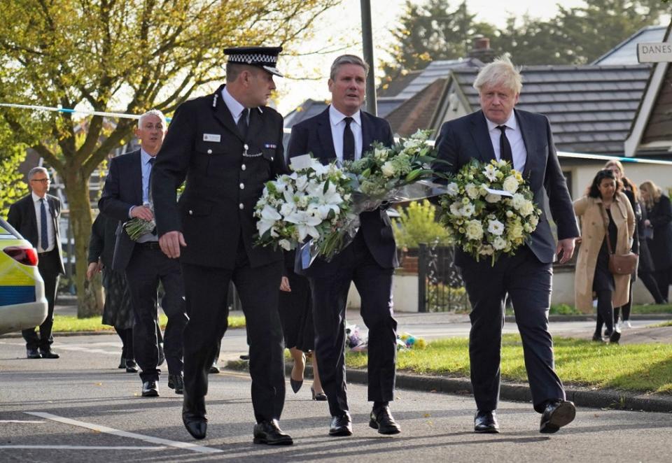 Essex Police Chief Constable Ben-Julian Harrington, Labour Party leader Sir Keir Starmer and Prime Minister Boris Johnson carry flowers as they arrive at Belfairs Methodist Church in Leigh-on-Sea to pay tribute to Sir David Amess (Essex Police/PA) (PA Media)