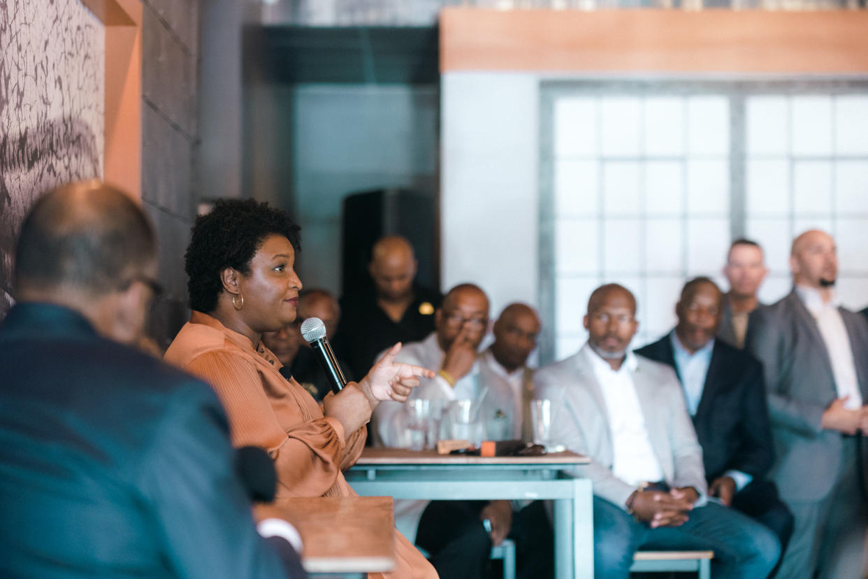 Stacey Abrams addressing a group of Black men